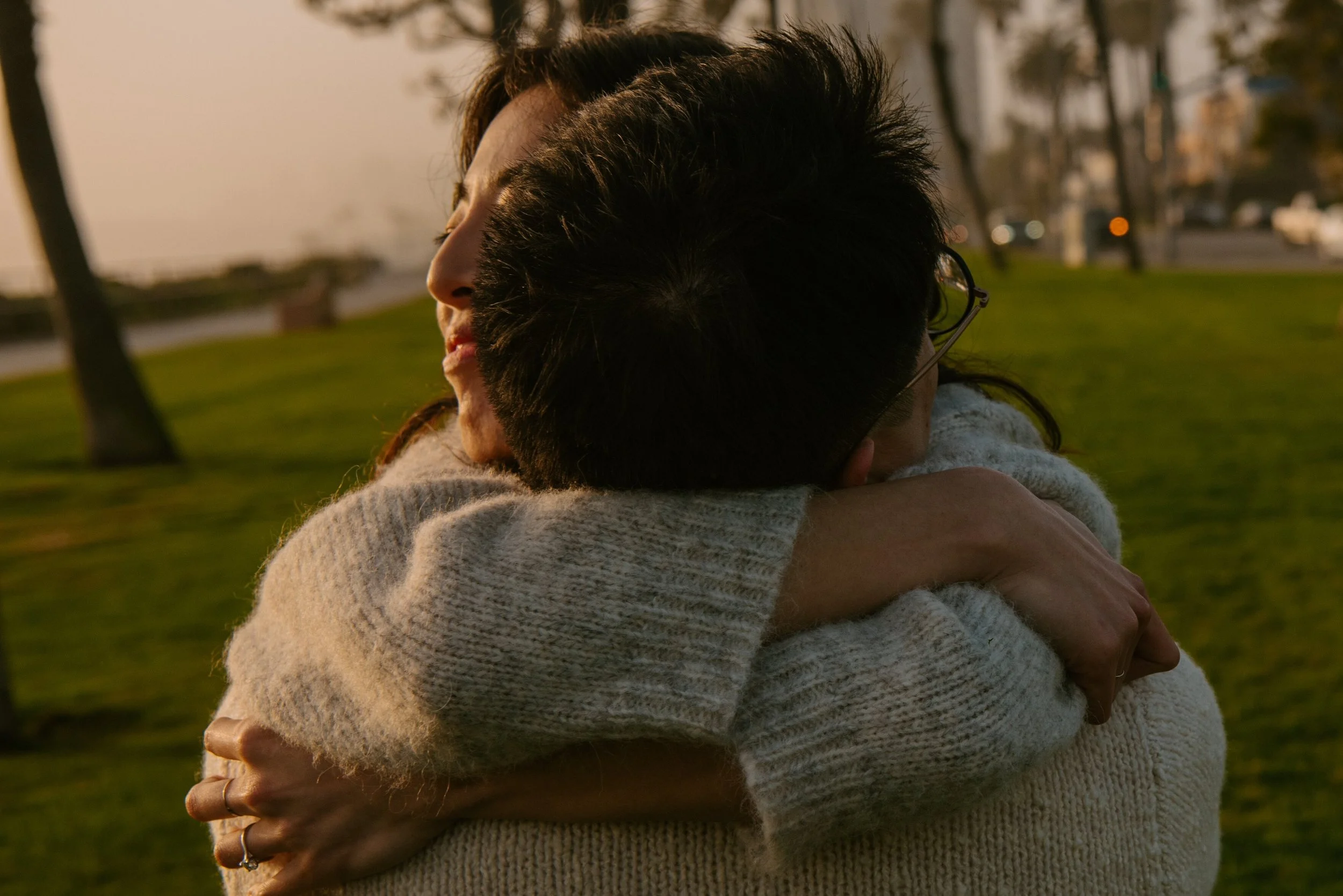 up close photo of girl hugging guy around the neck
