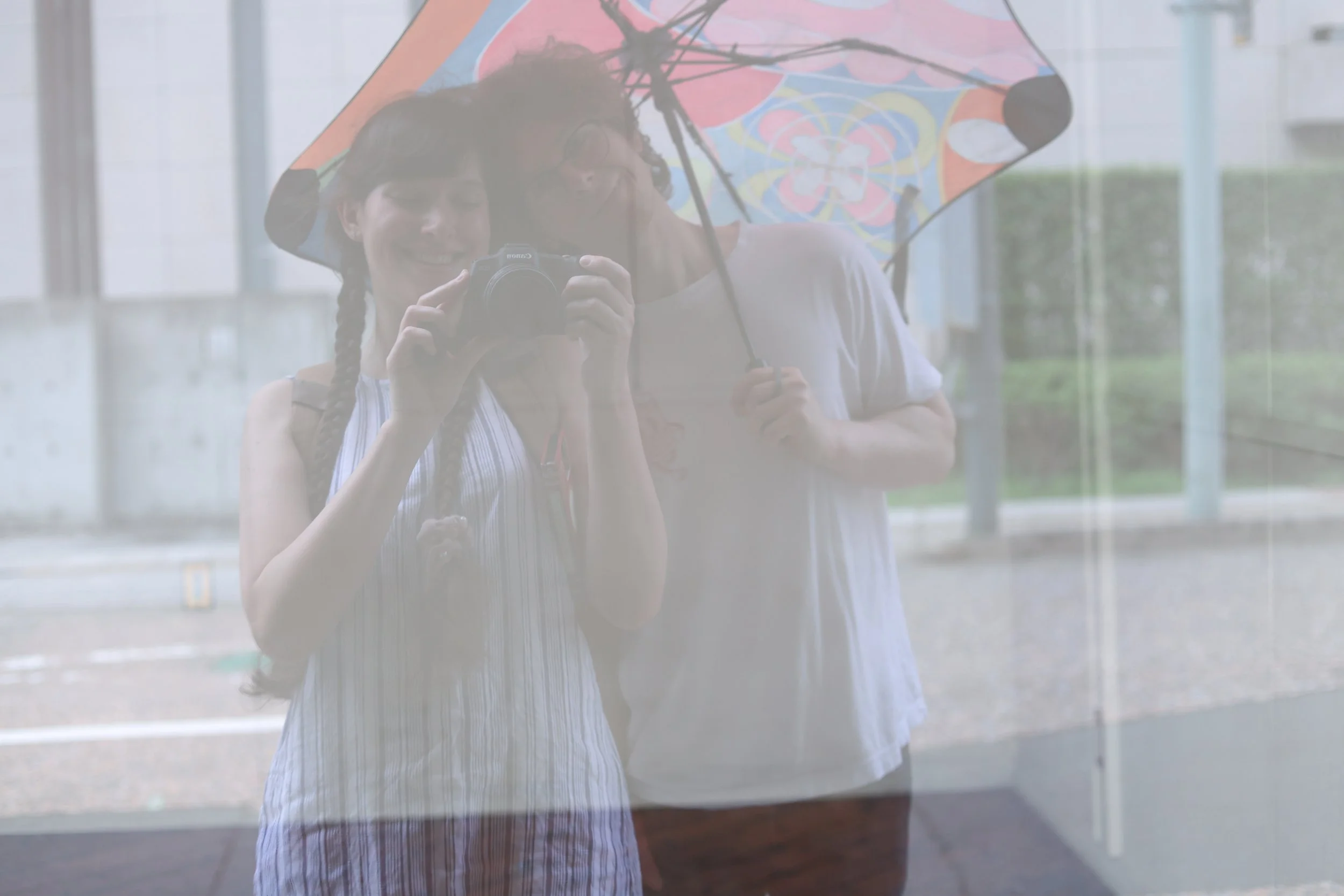 drifters in a window with umbrella
