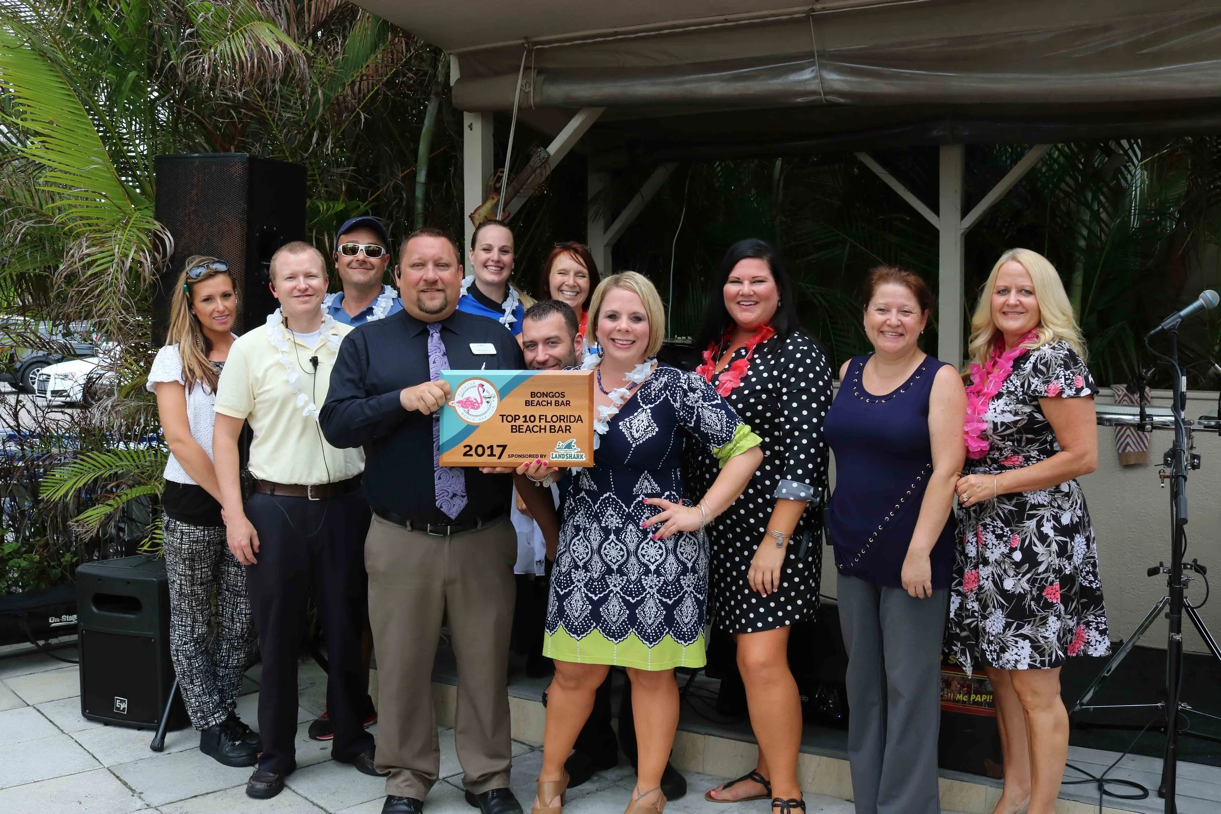 The staff of Bongos Beach Bar accepts the 2017 Top Florida Beach Bar award.