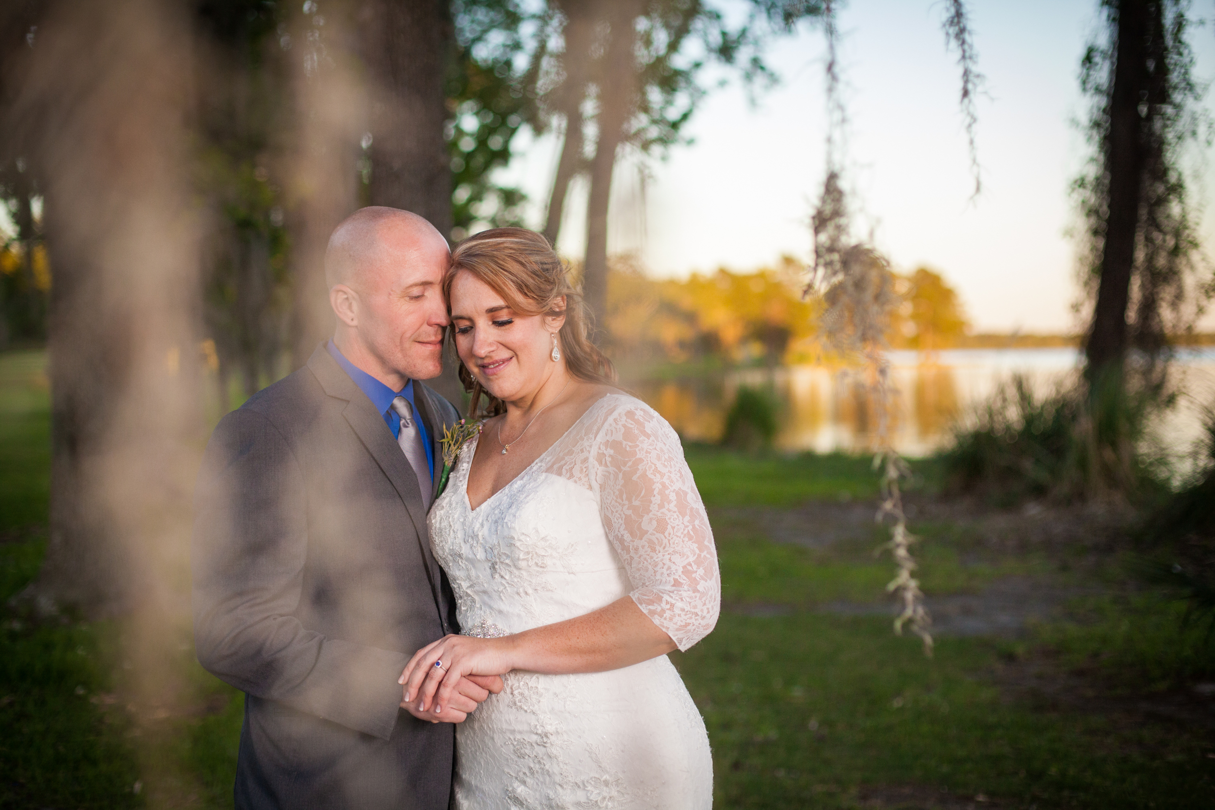 We steal the bride and groom away during the reception to capture some creative portraits just as the sun is beginning to set. This shot was taken through a weeping willow tree for a mystical and magical feel to the image.