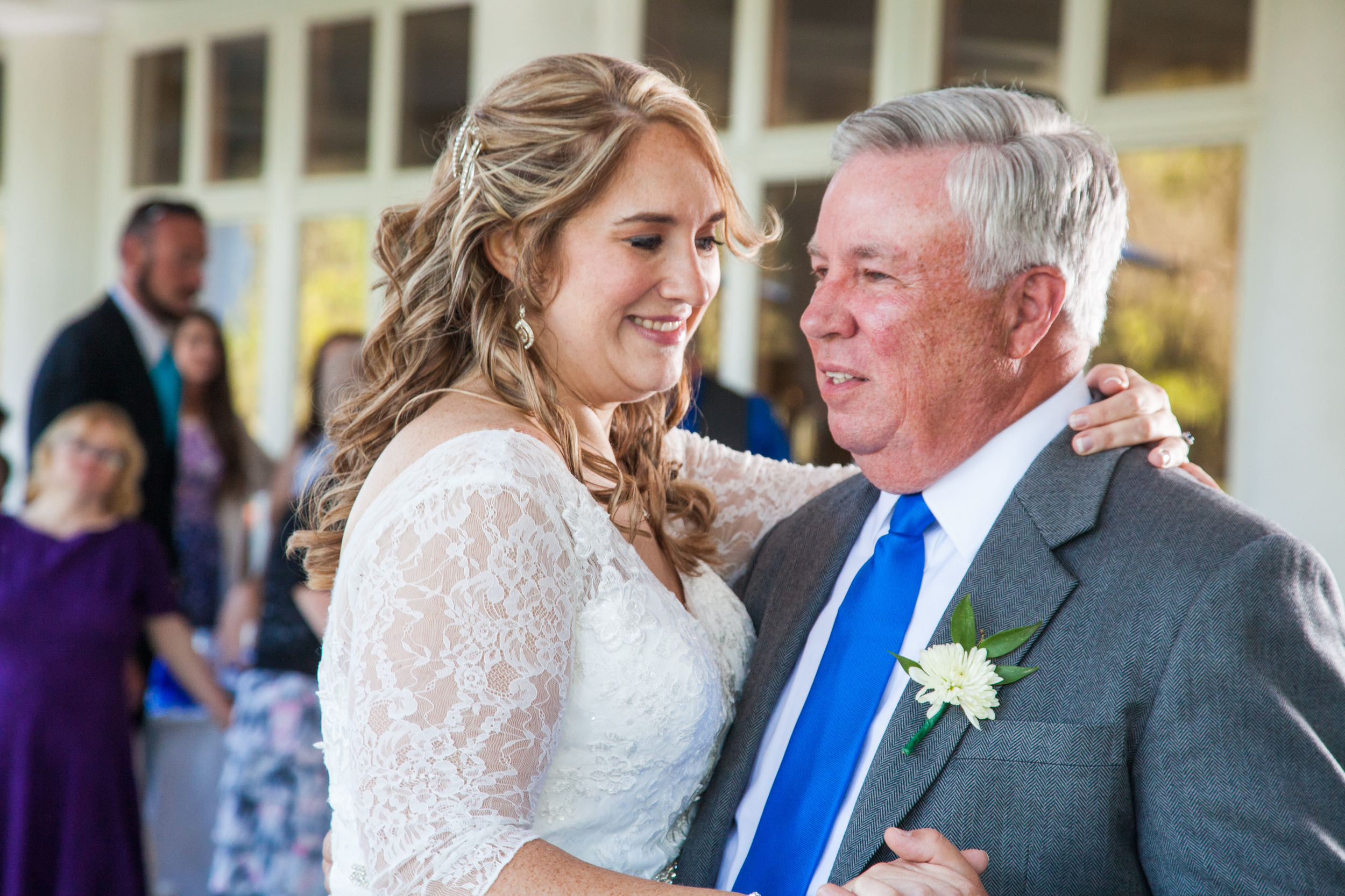 The father and daughter dance to a country song in front of an audience on the porch of the venue.