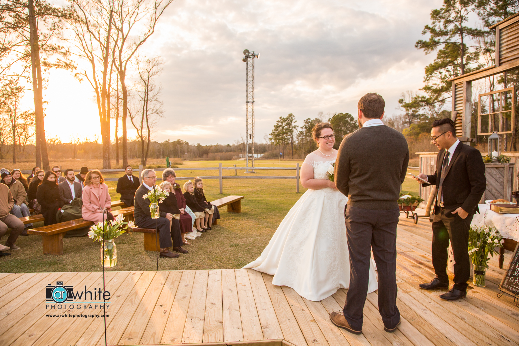 Barn wedding ceremony at sunset.