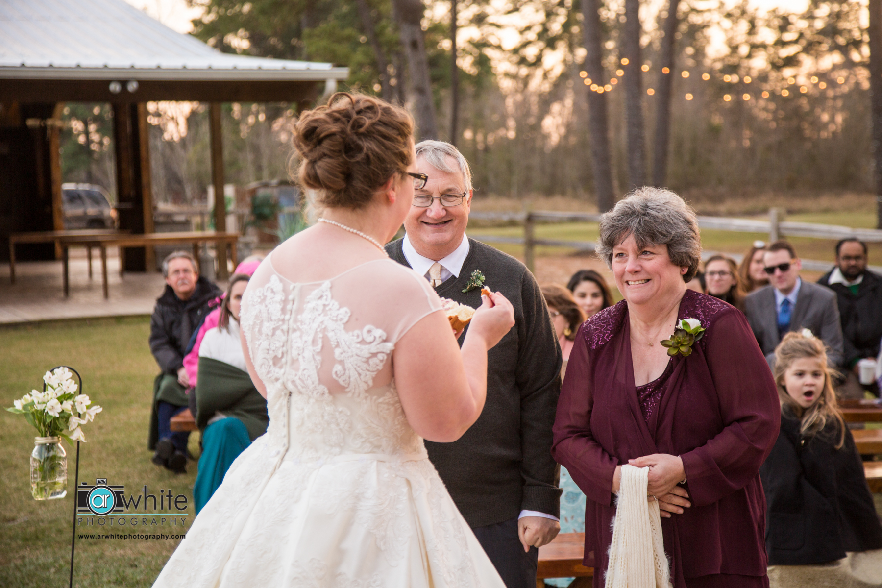 The bride gives her parents the bread offering at a farm wedding. 