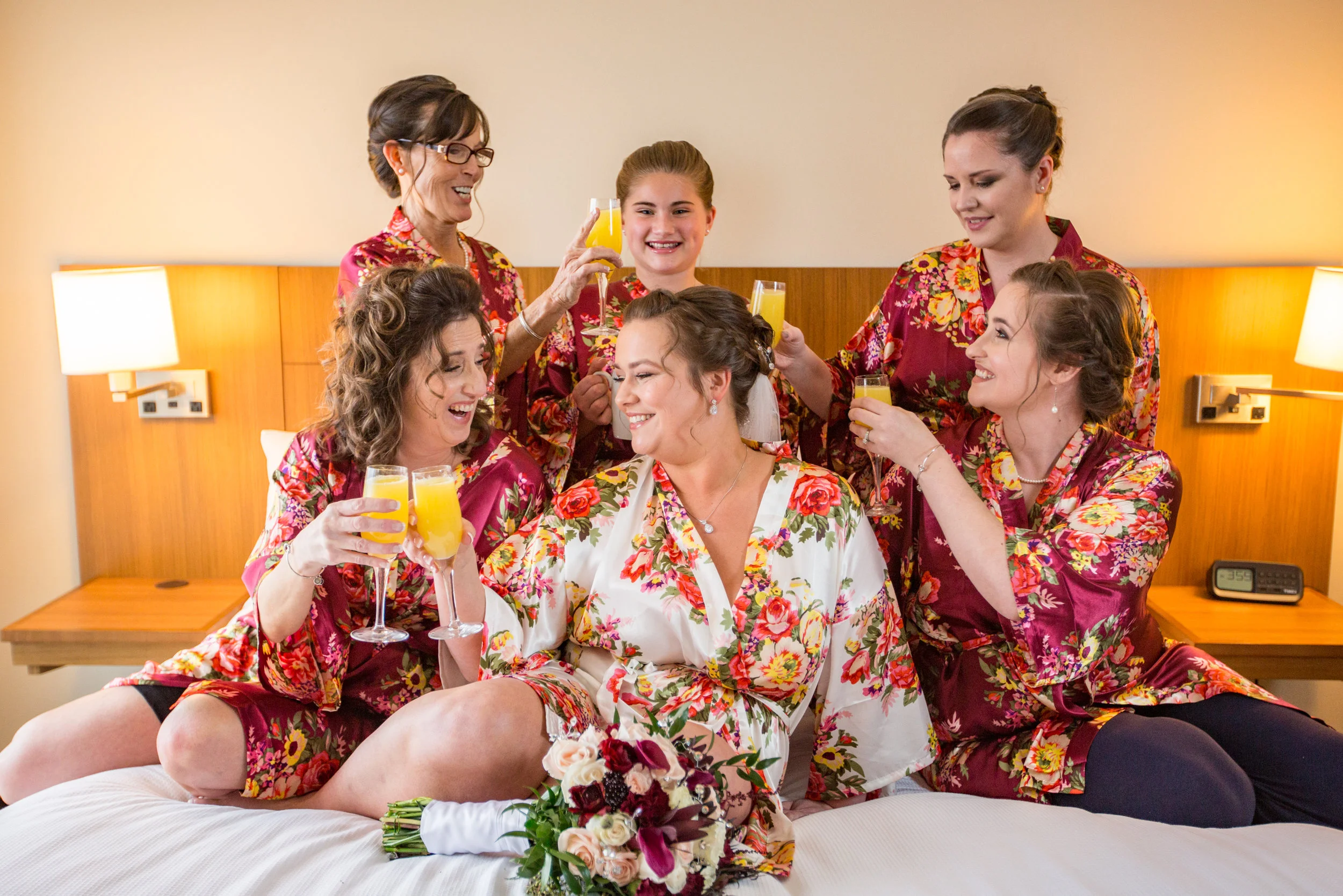 Jenna with her bridesmaids enjoy memosas in their gowns prior to getting ready for her big day in Ocean City, MD.