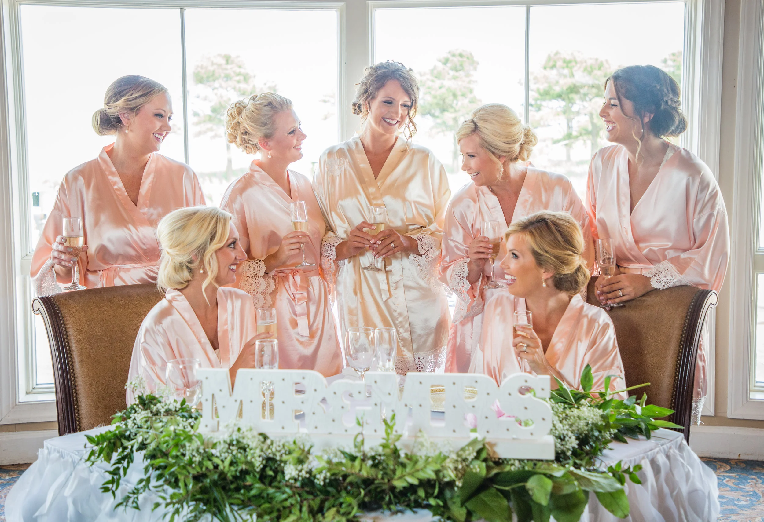 Bride with her bridesmaids get ready for the wedding at Lighthouse Sound. Planning and styling by https://alisontothealtaroc.com/