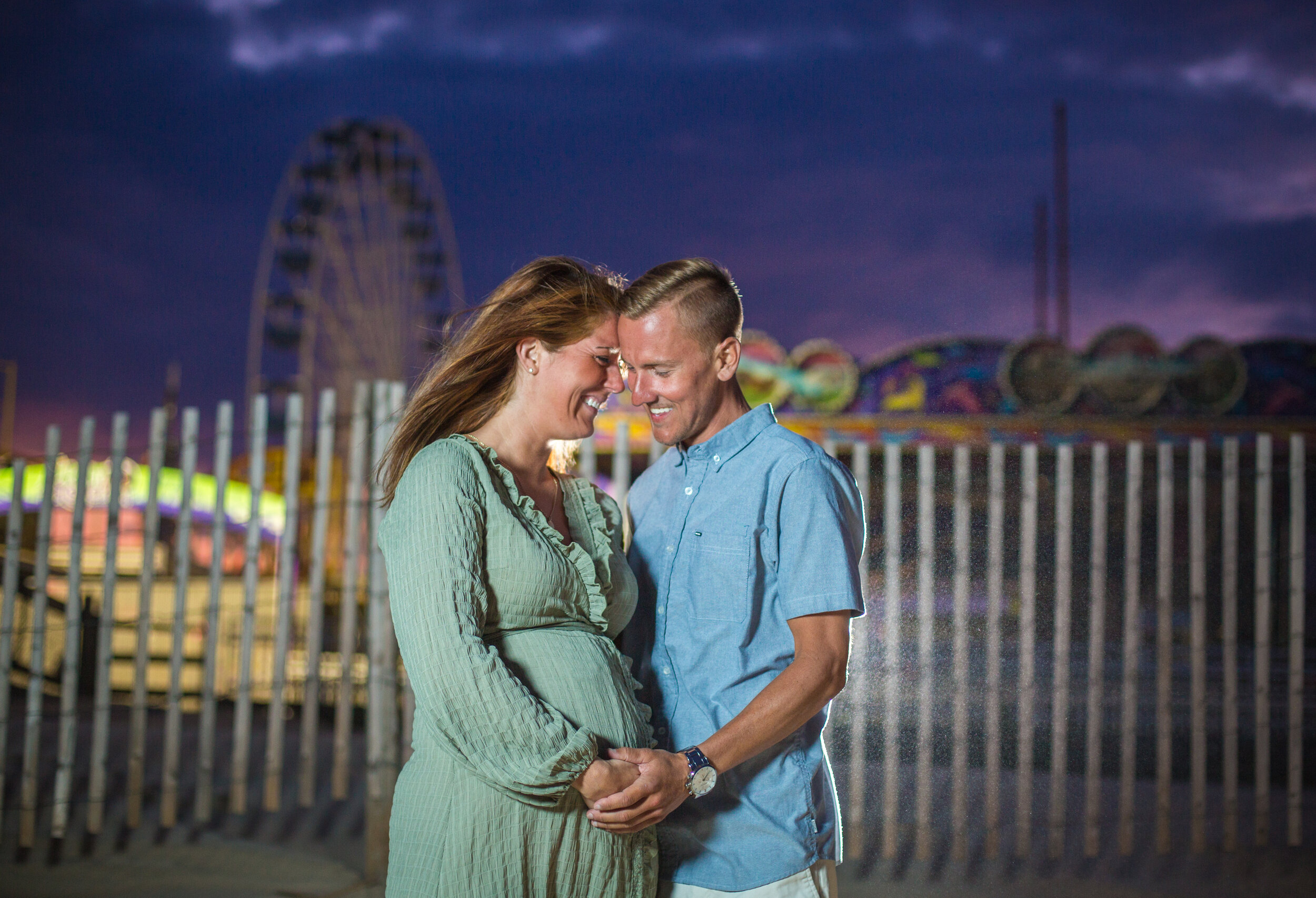 Photo of a pregnant woman and husband during their maternity shoot in Ocean City Maryland taken by photographers in OCMD ARWhite Photography. (Copy)