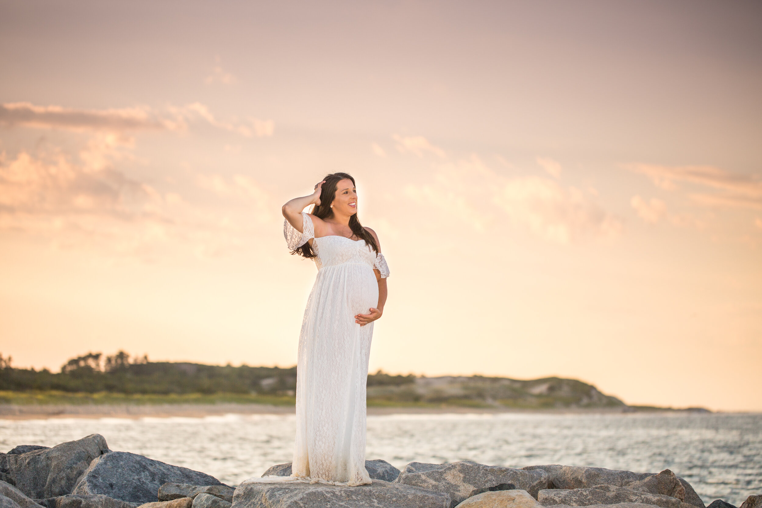 Photo of a pregnant woman in long flowy pink dress on the beaches of Cape Henlopen State Park during her Lewes beach session taken by photographers in Ocean City Maryland ARWhite Photography. (Copy)