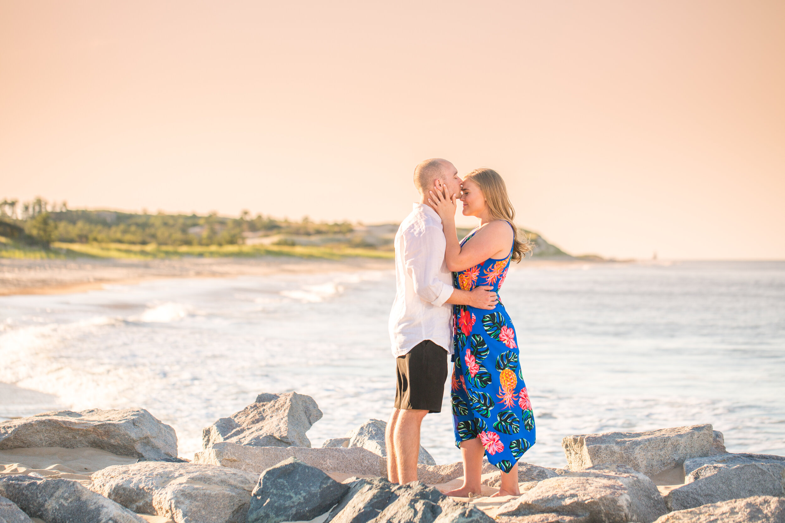 Photo of a young couple standing on a jetty on the beach at Cape Henlopen State Park taken by wedding photographers in Baltimore ARWhite Photography (Copy)