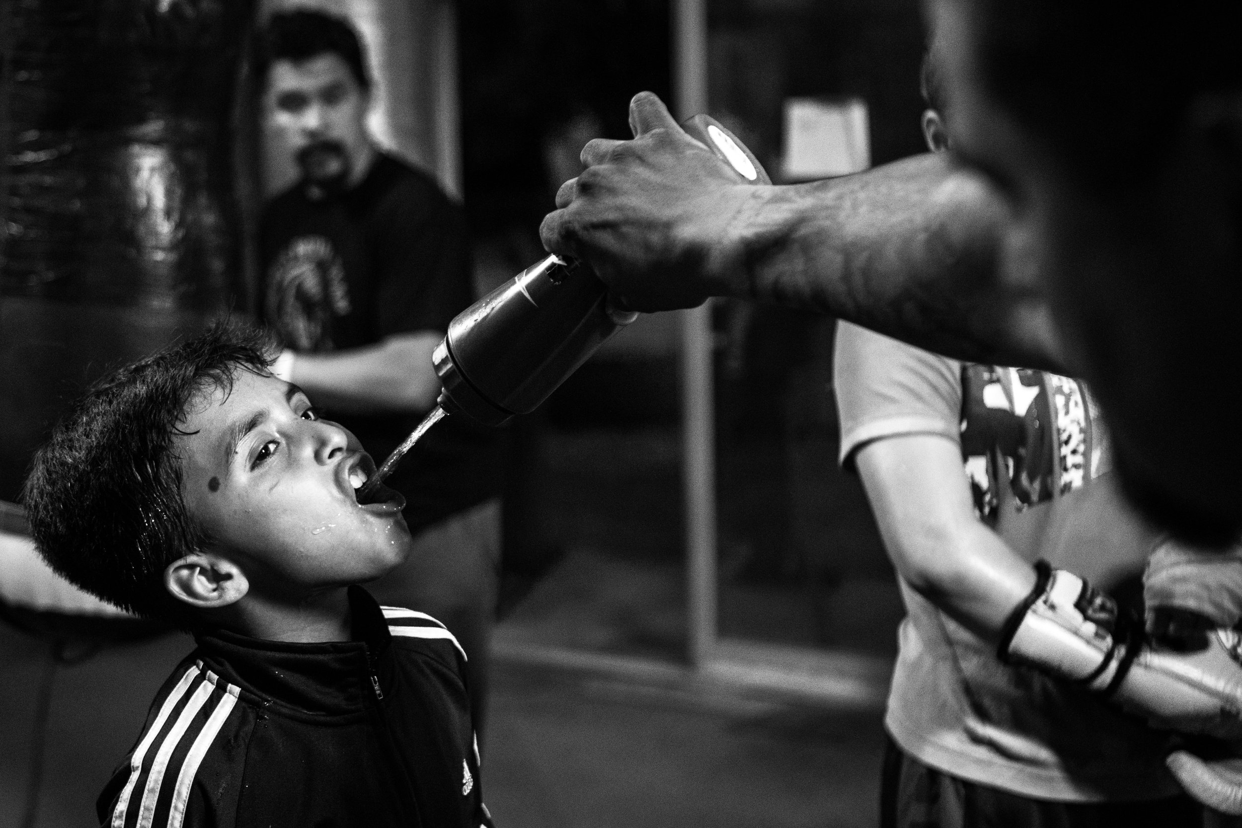  Miguel Ángel Jacobo Jr., 9, &nbsp;drinks water during a break between punching bag drills. Jacobo has only recently been registered as an amateur fighter though he has been boxing since age six. "I get pretty nervous when I'm in the ring," Jacobo sa