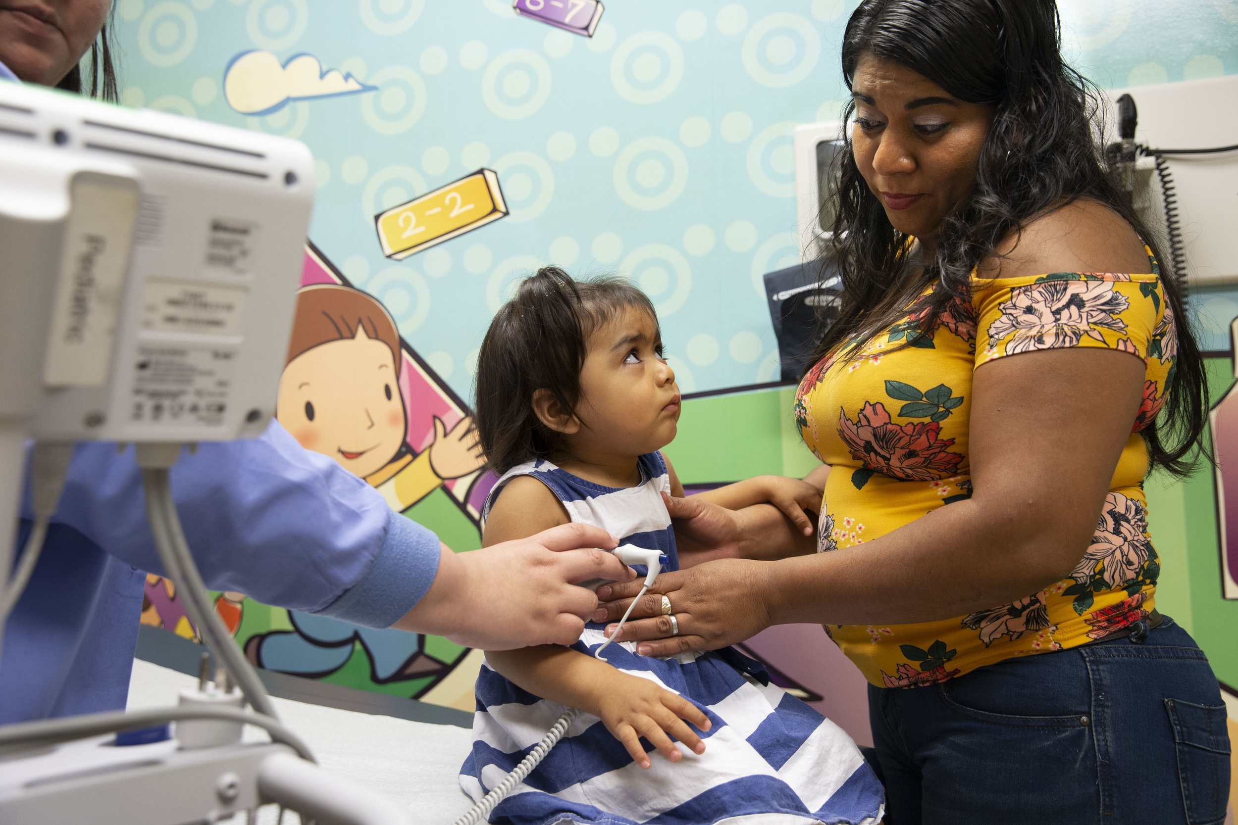  Rosales holds her 2-year-old daughter Kelly during a doctor's appointment in Kyle, Texas, on Friday, June 22, 2018. 