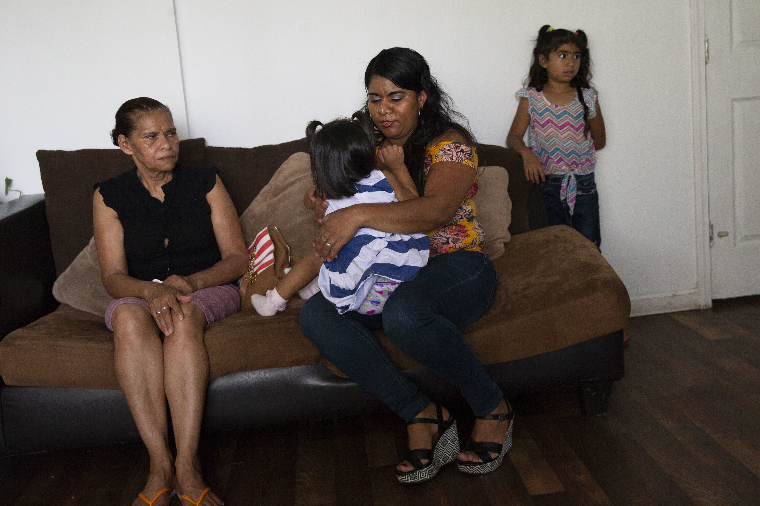  Rosales, an asylum recipient from Honduras, sits with her mother, Rosa, and her 2-year-old daughter, Kelly, in the living room of their mother mobile home in Kyle, Texas, on June 22, 2018. 