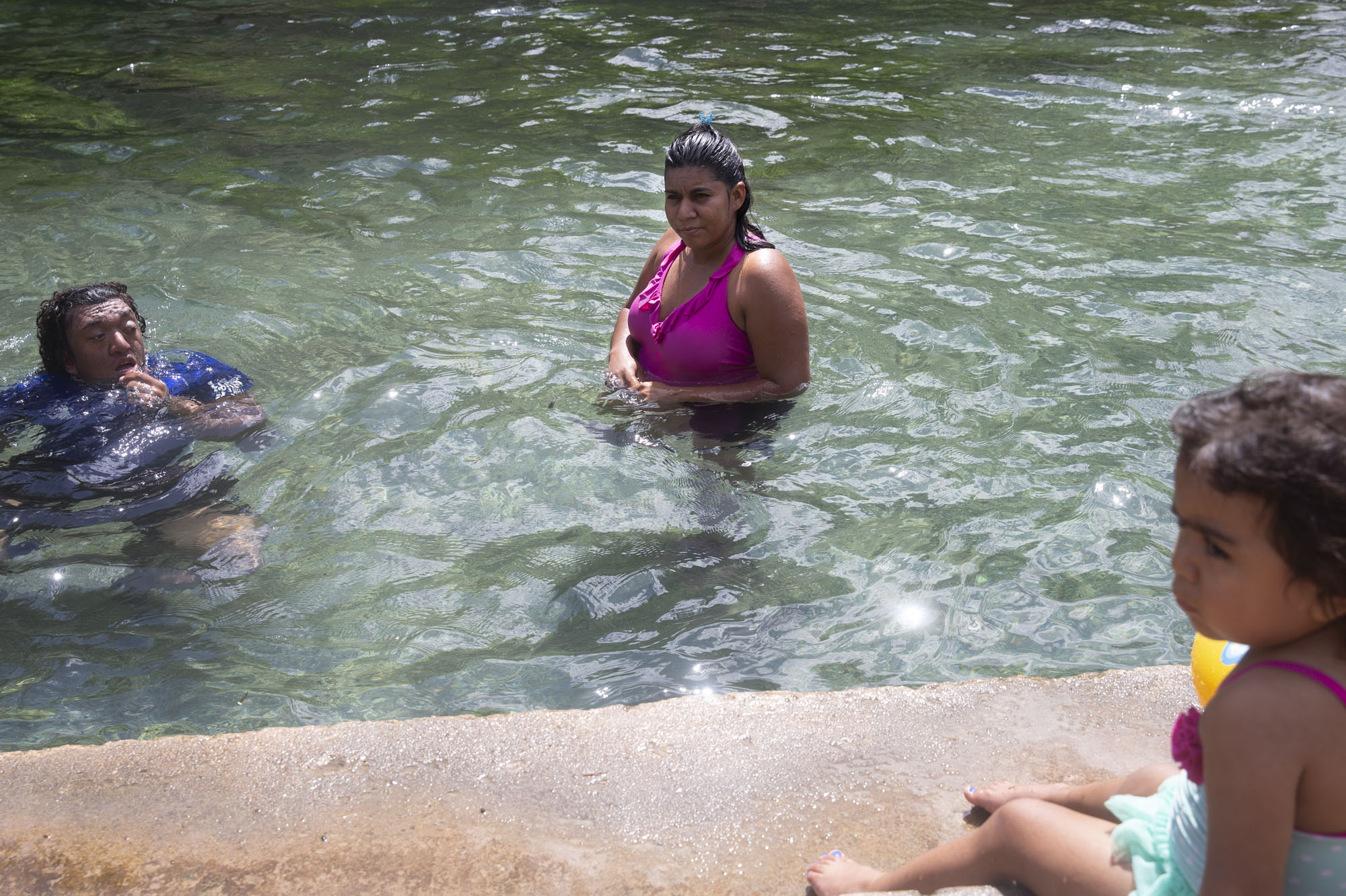  Lizeth Rosales, center, goes to the San Marcos river with her brother, left, and her 2-year-old daughter.  