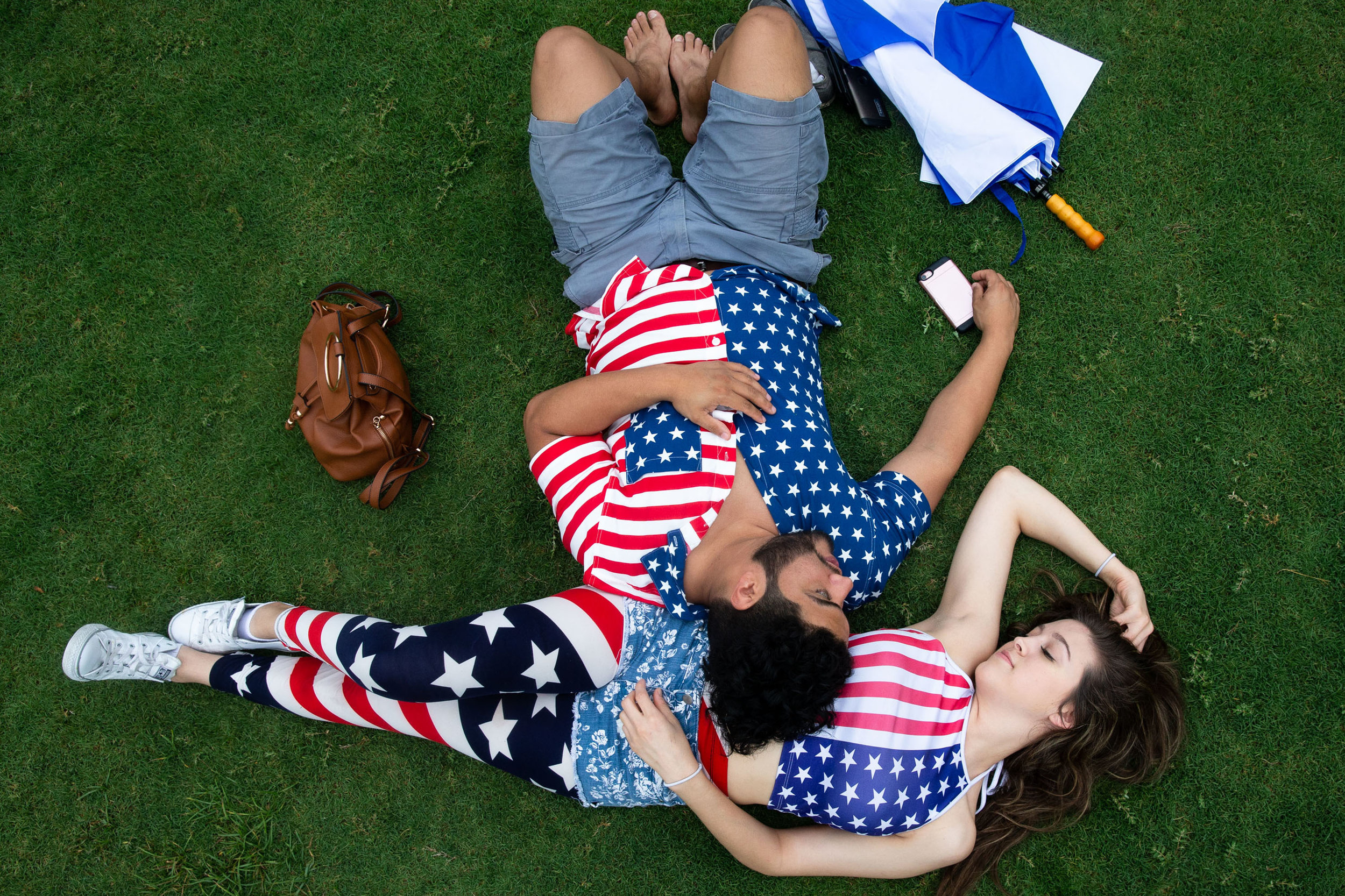  Jonathan Salas and Daisy Escamilla lay down on the Vic Mathias Shores lawn before the H-E-B Austin Symphony July 4th Concert &amp; Fireworks celebration on Wednesday. 