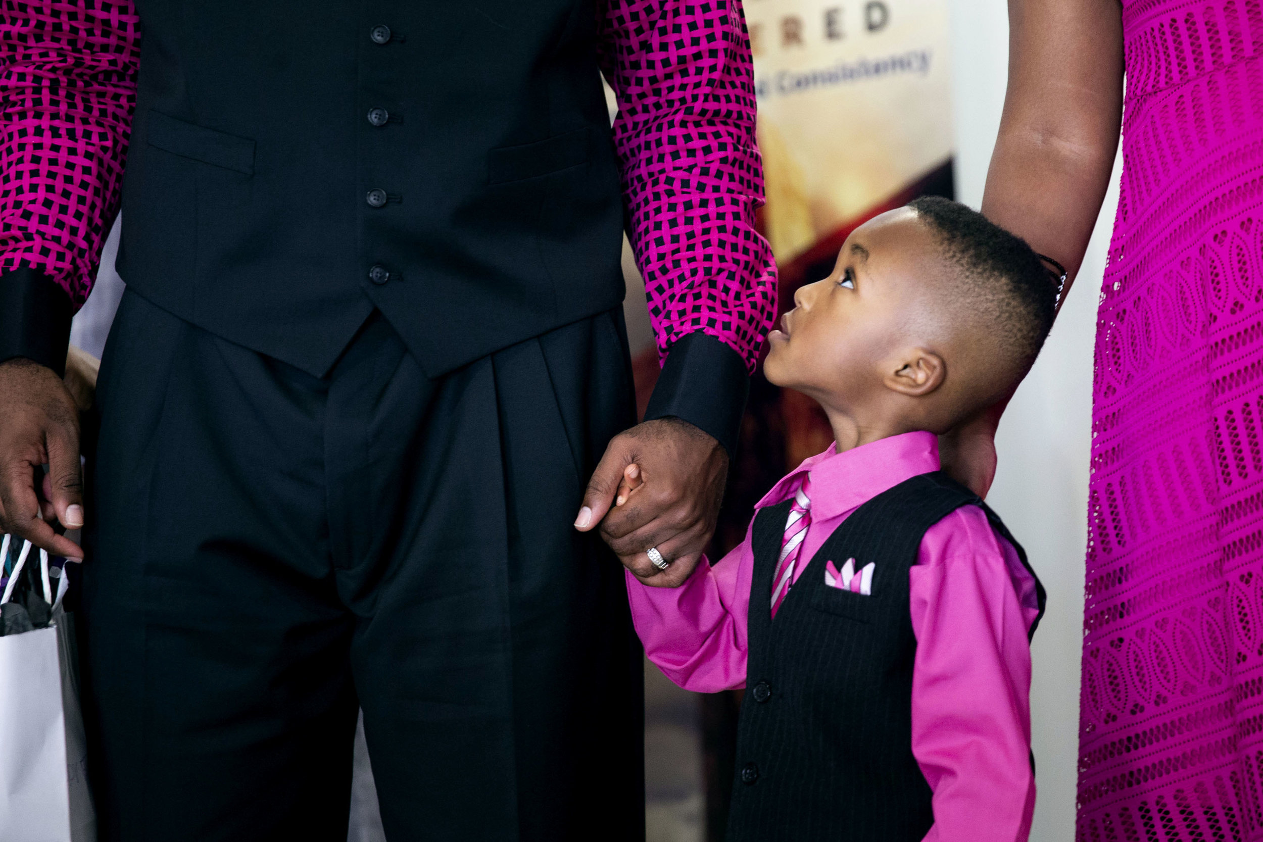  Brycen, 5, looks up at his father following the Church of Christ at East Side's annual Father's Day celebration on Sunday, June 17, 2018. The celebration concludes with a group photo that the church minister, George Williams, says is “a testimony to