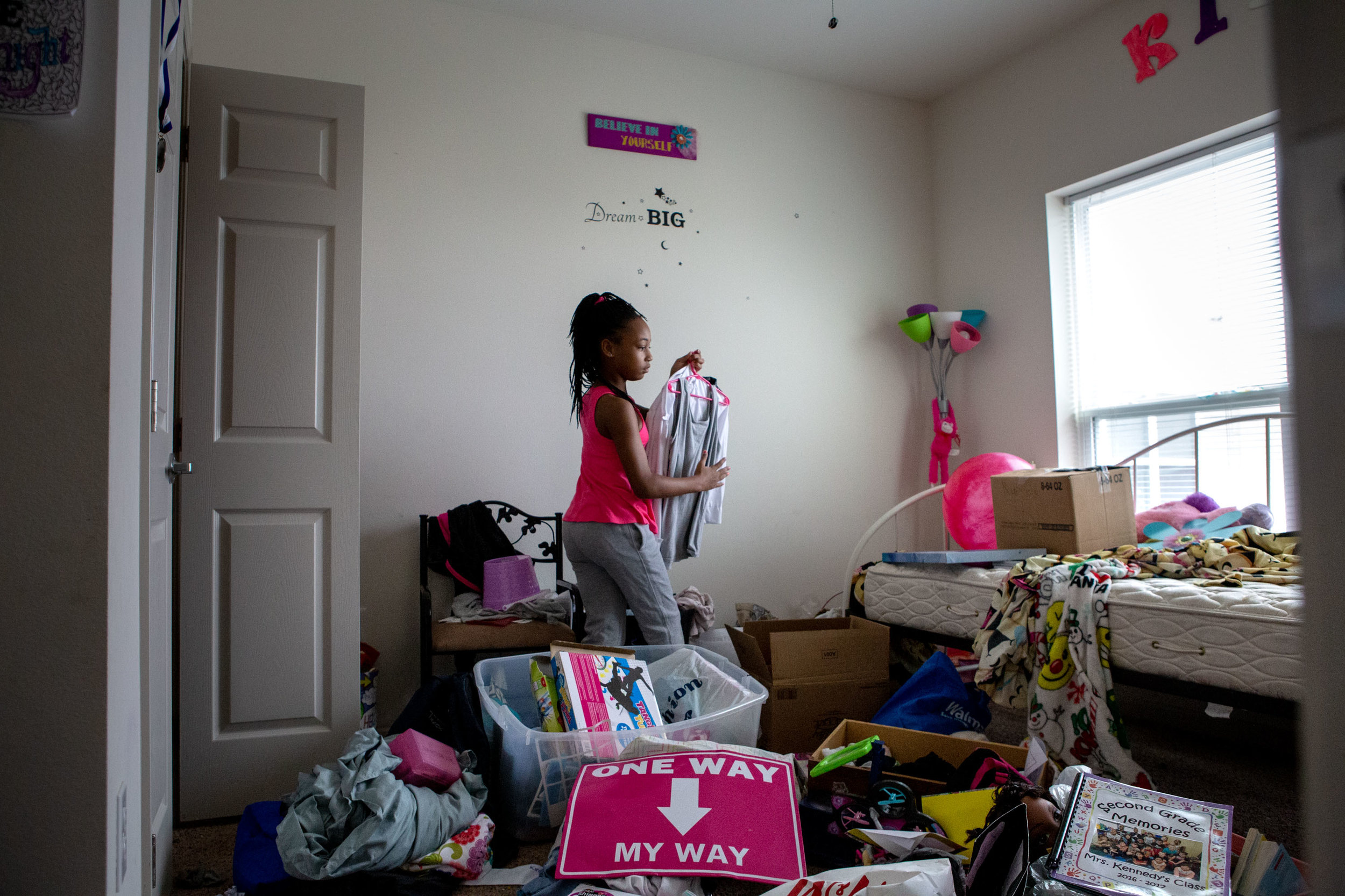  Kira Roberts, 8, packs up her belongings from her mother’s home at The Reserve at Springdale apartment complex. Robert’s mom, Robin McGee, was ordered to evict after a continued dispute with apartment management. 