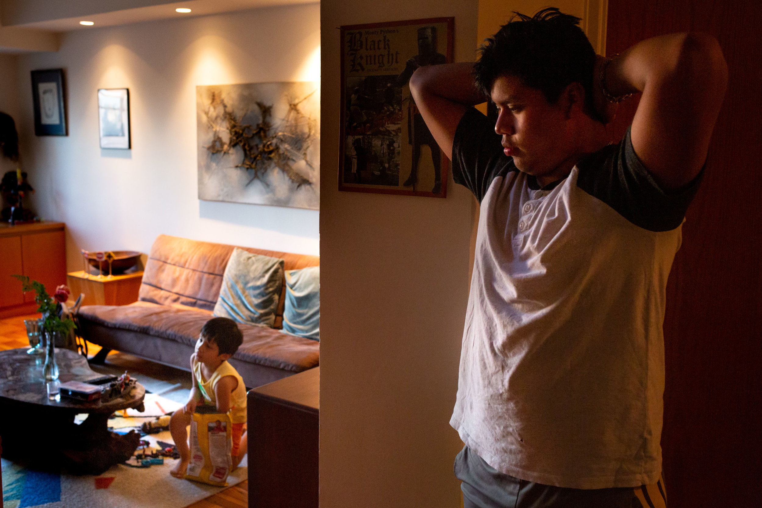  Yordy Michikoj, 16, watches as his brother Fernando, 6, watches television in their Upper East Side apartment in Manhattan. From Guatemala, the two boys were separated from their mother after crossing the U.S. Border to seek asylum as a result of th