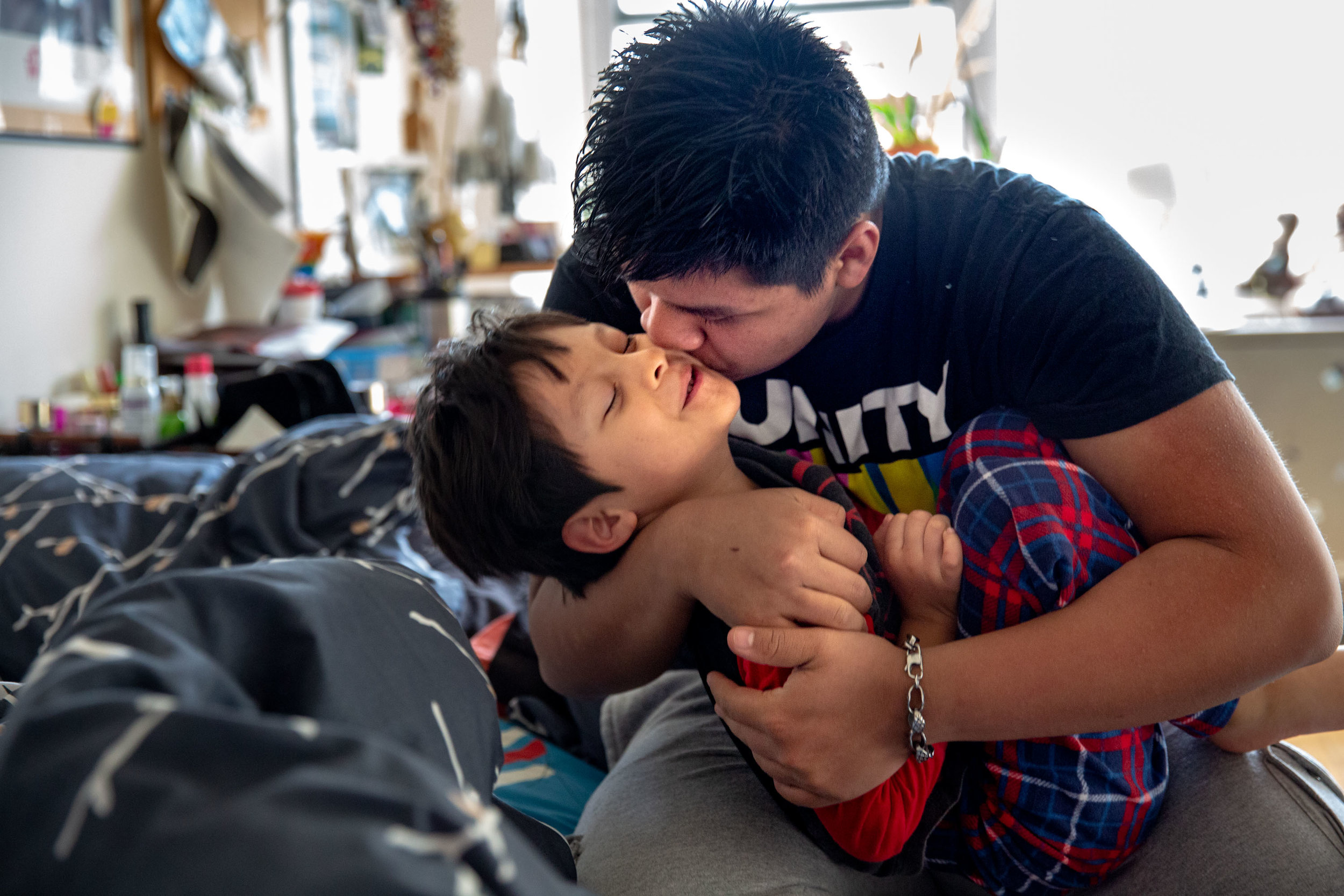  Yordy Michikoj, 16, coaxes his brother, Fernando, 6, to wake up and get ready for school one morning in their Upper East Side apartment in Manhattan. From Guatemala, the two boys were separated from their mother after crossing the U.S. Border to see