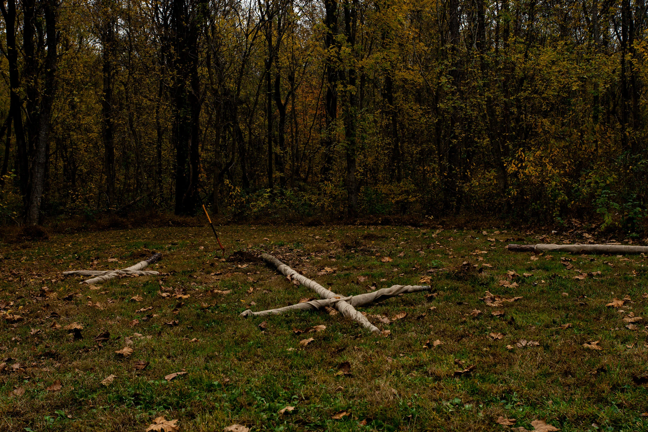 In preparation of a Klonvocation ceremony, wood is assembled in to crosses and wrapped with burlap.