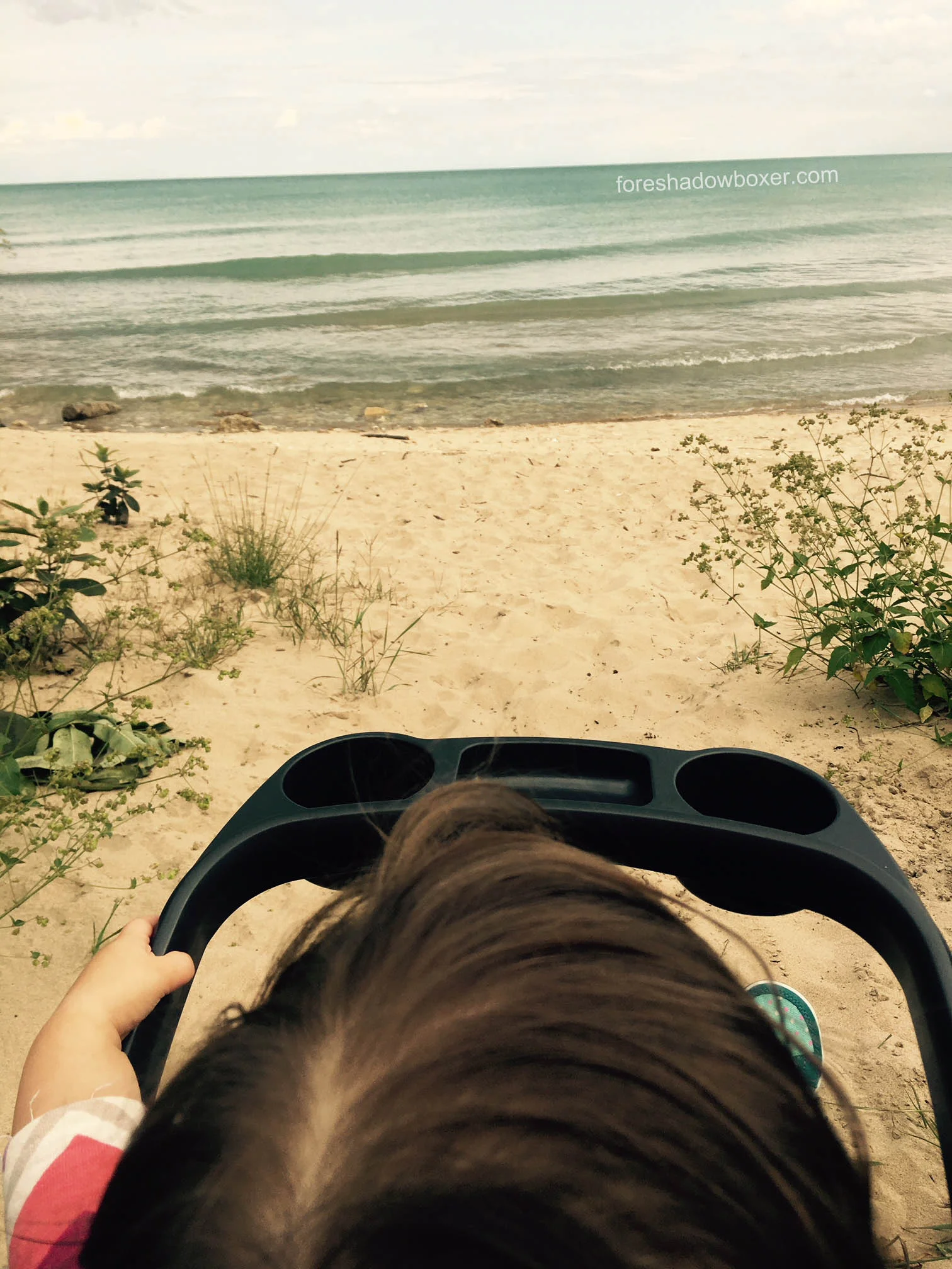 Don't let this photo fool you: the Chicco Bravo Trio Travel system does not work well on sand (we had to carry it to this location for our daughter to see the lake). Plus, the tray shown here must be ordered separately.