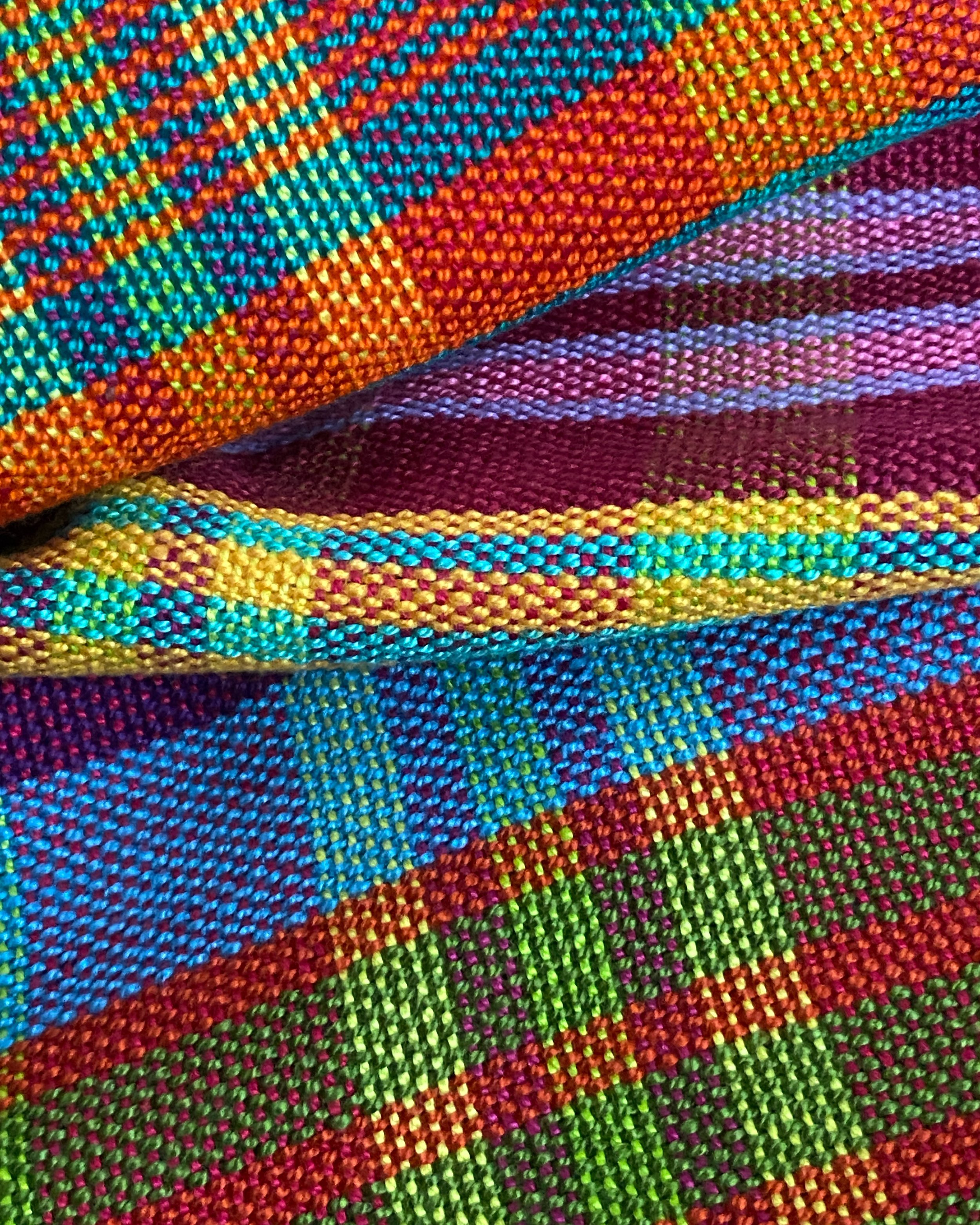 Handwoven plaid cotton hand towel feature a dizzying array of vibrant stripes (close-up)