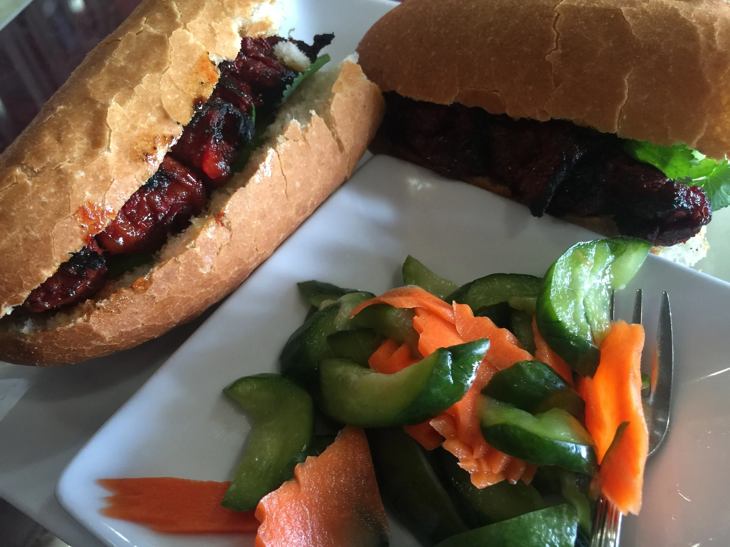 The beef sandwich is served with vegetables for the enjoyment of those who go to Monorom Cambodian Restaurant.