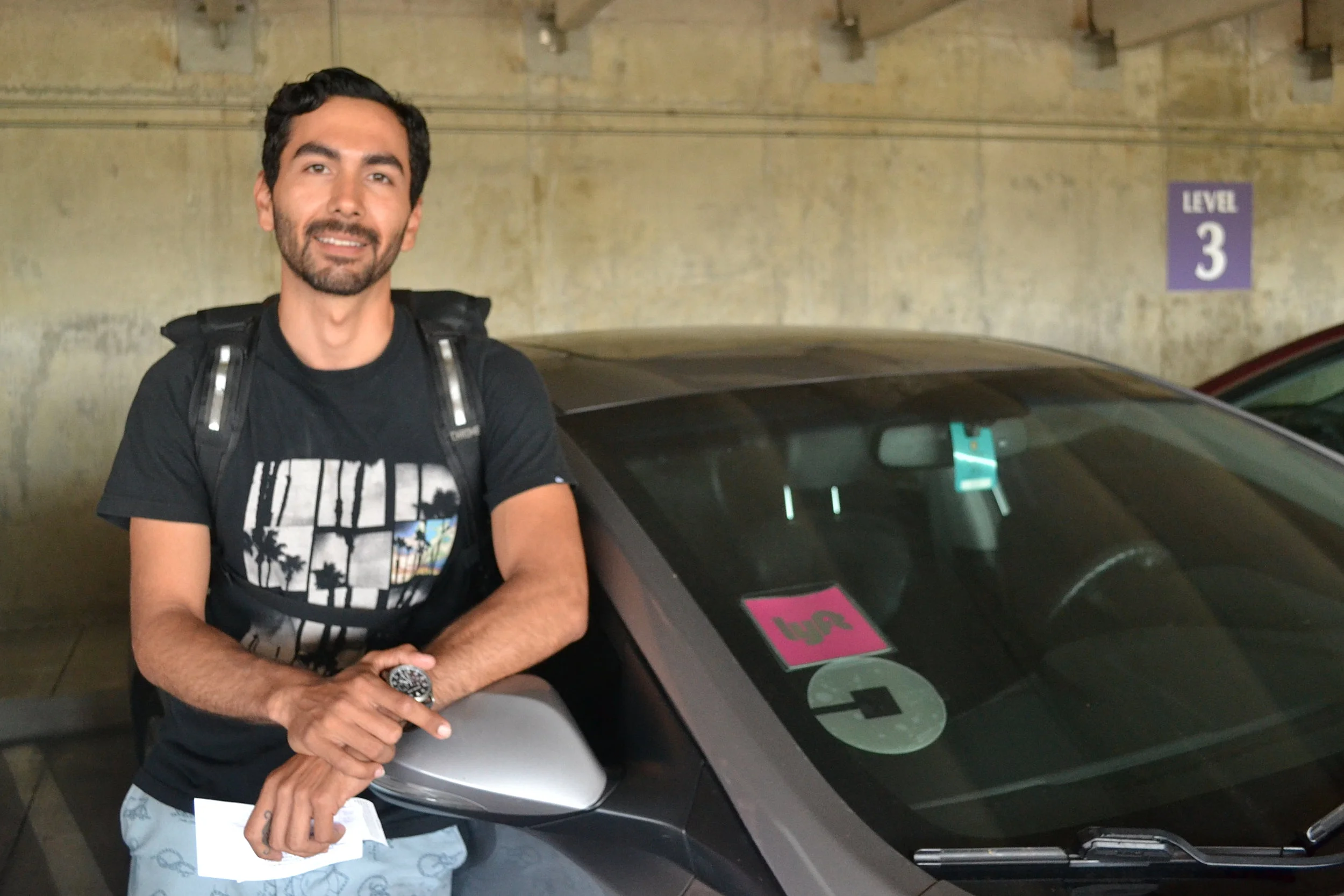 Hector Miramontes with his 2013 Hyundai Elantra, which he uses for both Lyft and Uber when he's not riding his bicycle.