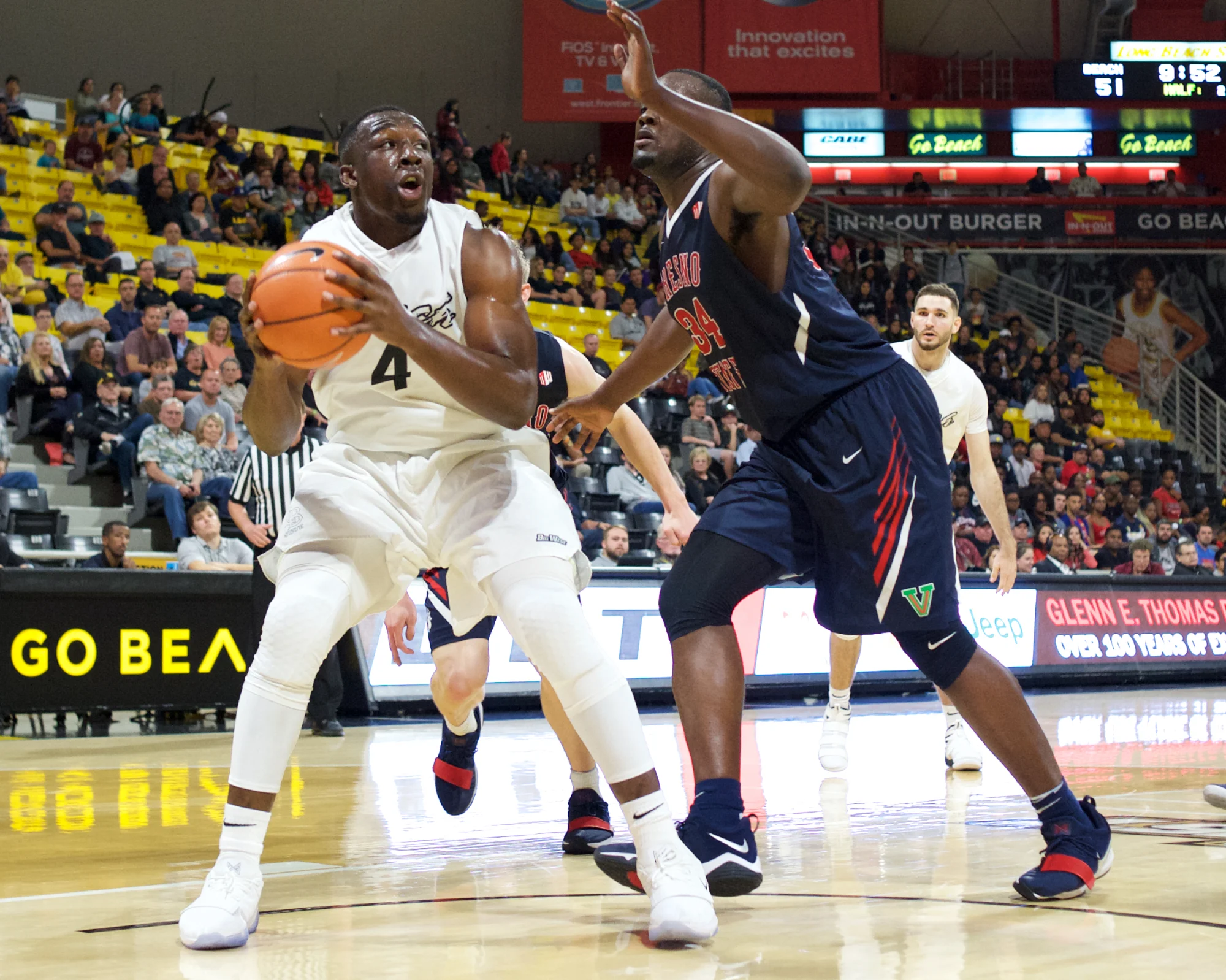 Long Beach State senior center Temidayo Yussuf (4) posting up against Fresno State’s Terrell Carter II (34). Credit: Long Beach State Athletics/John Fajardo
