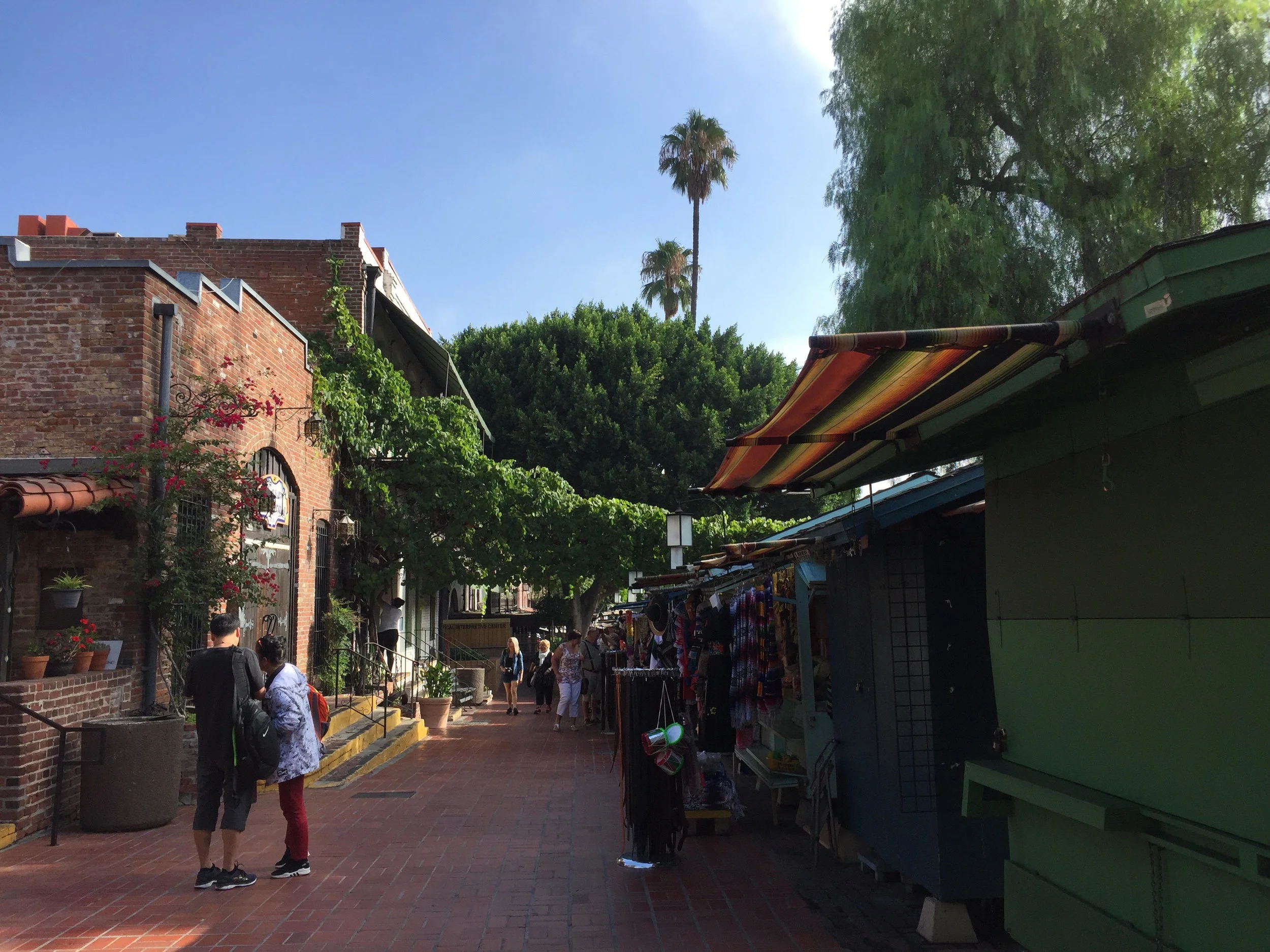 Vendors and small shops line Olvera Street.