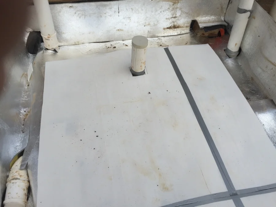 The insulation on top of the black plastic and turned up to cover the concrete yet to be poured, with the corduke on top to increase the efficiency and protect the insulation.