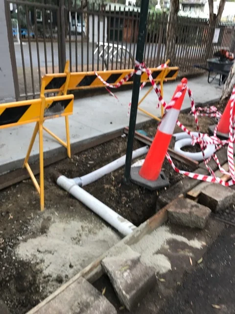 • Here, the rain that becomes water from the adjoining site and from the footpath is being kept below ground by the leaky pipe. The next step is to put soil over then plant the plants