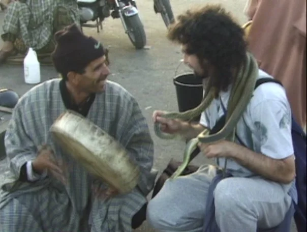 Chatting with a snake charmer in the main Medina in Marrakech, everything was OK till he put the cobra in my face :-/ Click anywhere on the image to bring up the lightbox, roll mouse over the image, and then click on the underlined link in description to go to the youtube video.