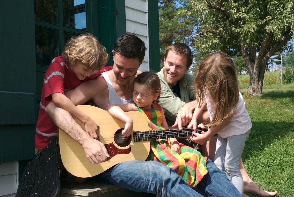 Pat with guitar & family on vacation.jpg