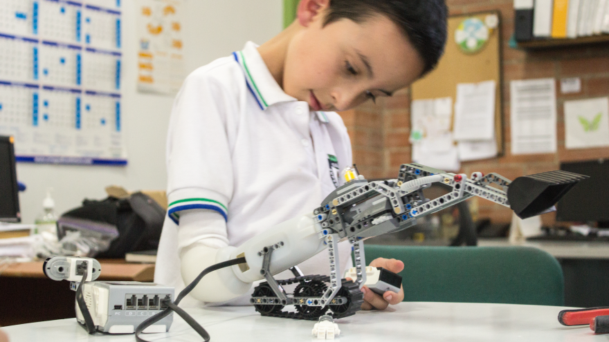 Boy Playing with Lego Robot Arm