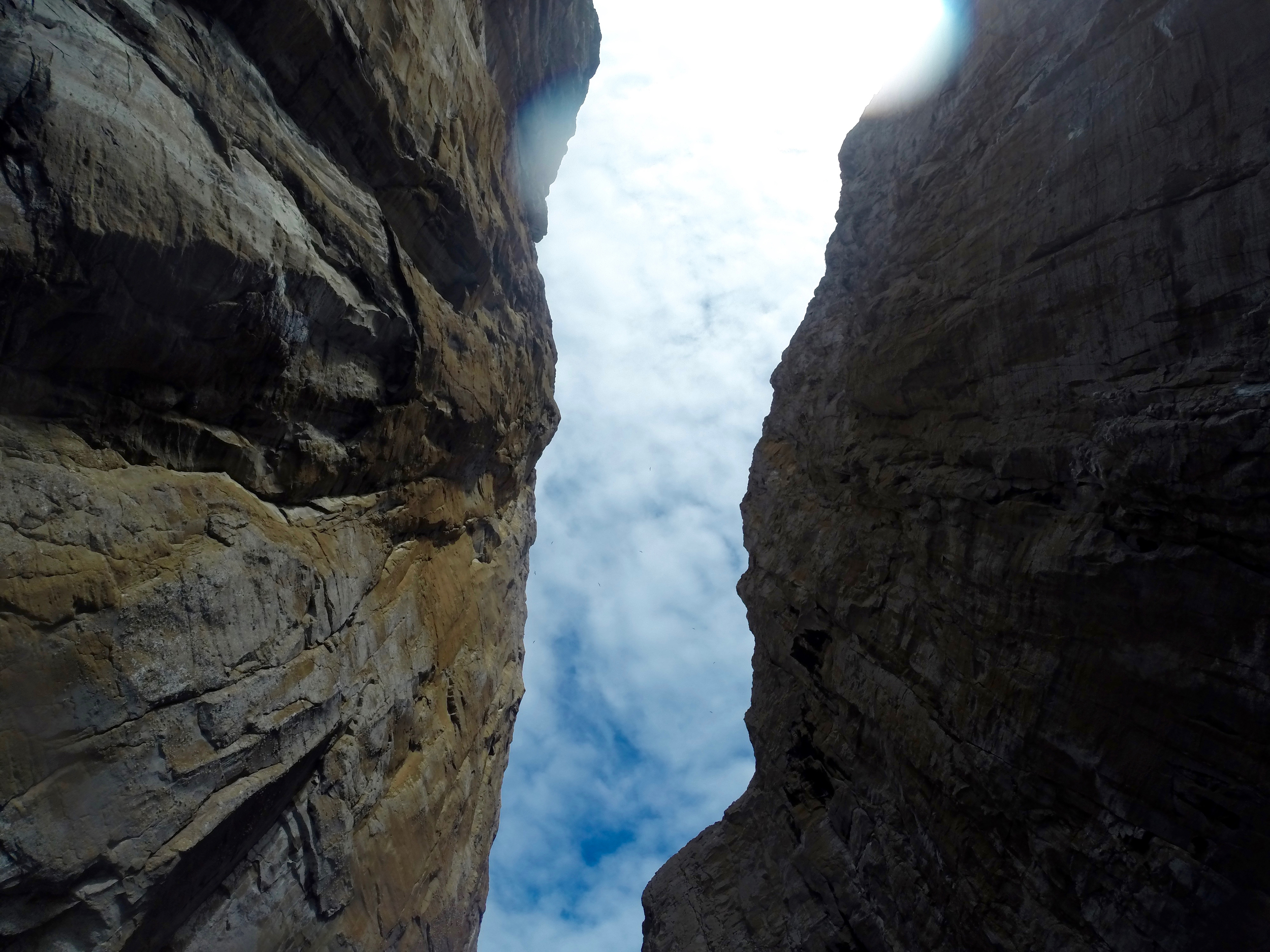 Looking up at the high cliffs of Kicker Rock