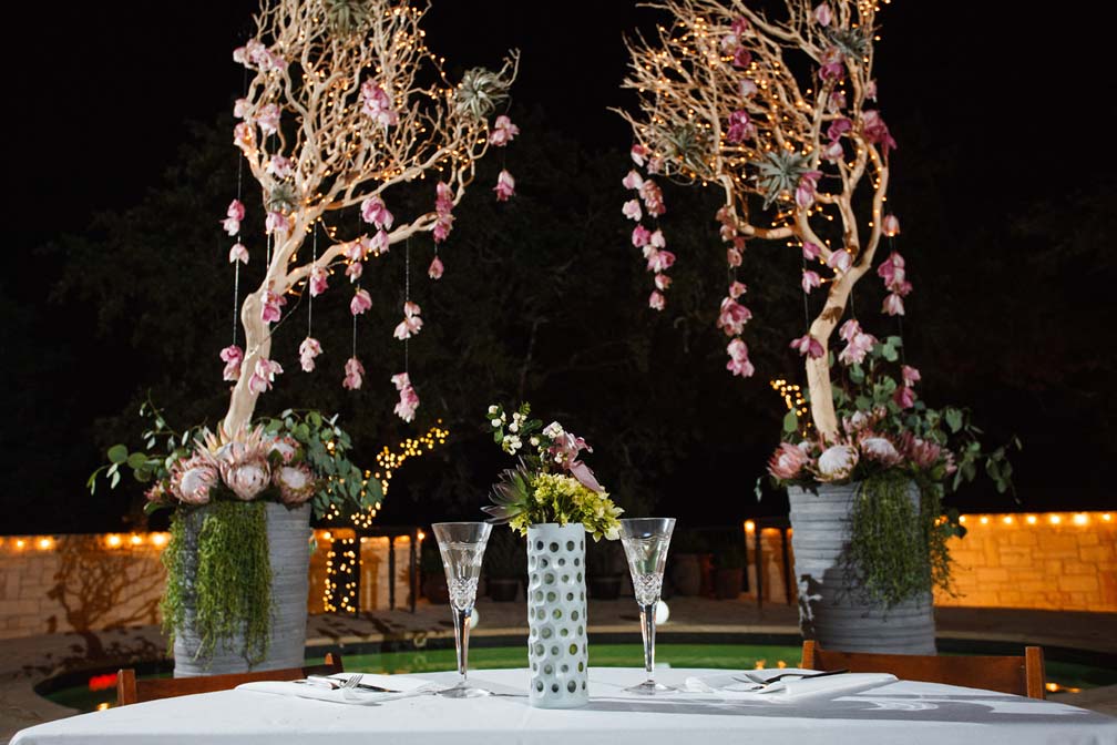 bride & groom table | hanging orchid altarpiece photo: Jake Holt Photography