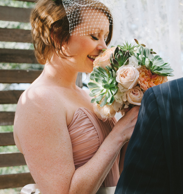 bride with succulent and rose bouquet | Texas Hill Country wedding photo: Nathan Russell