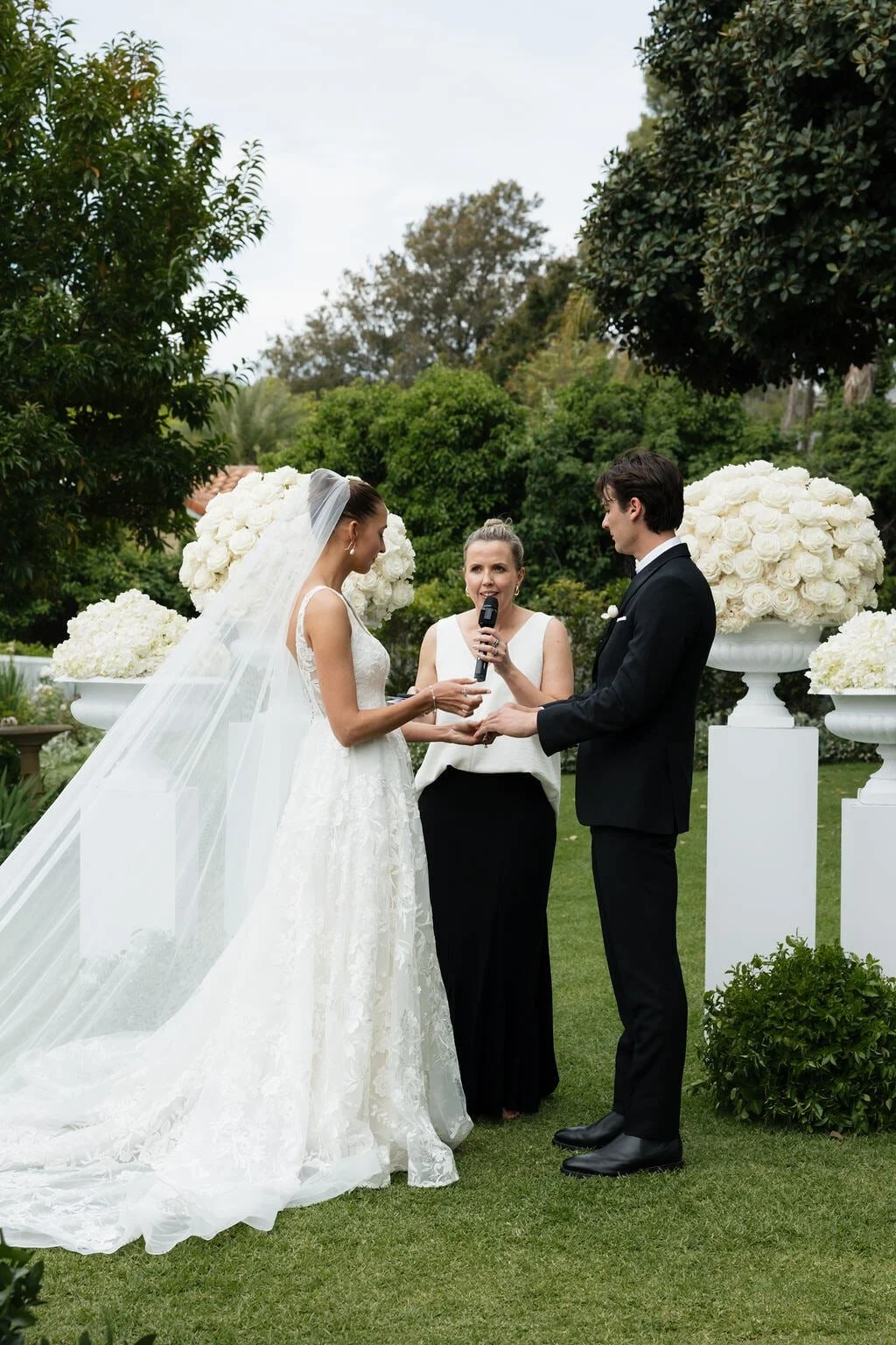 adelaide-wedding-celebrant-reading-vows-with-floral-urns.jpg