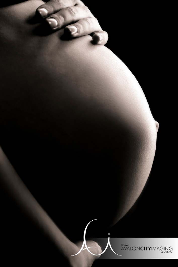 Maternity photography showing baby bump close up