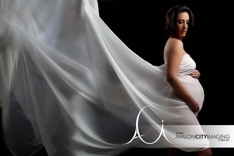 Draped in white sheet for Maternity photograph