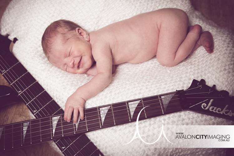 Newborn photography – baby playing guitar