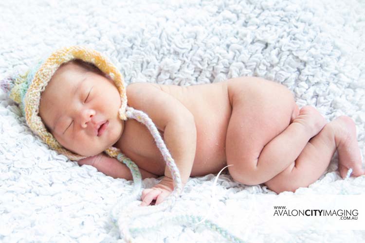 Newborn photography – cute baby wearing a bonnet or beanie