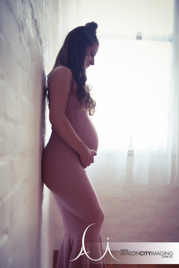 Maternity art photograph of lady in dress and lovely lighting