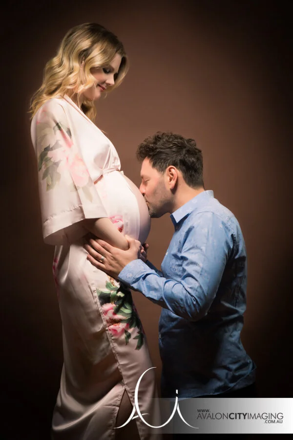 maternity photography - expecting parents in a warm, connected pose with gentle highlights.jpg