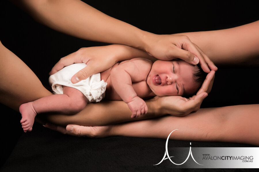 Newborn photography – baby wrapped in hands