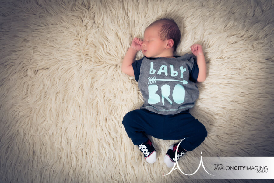 Newborn photography – baby brother wearing funny t-shirt