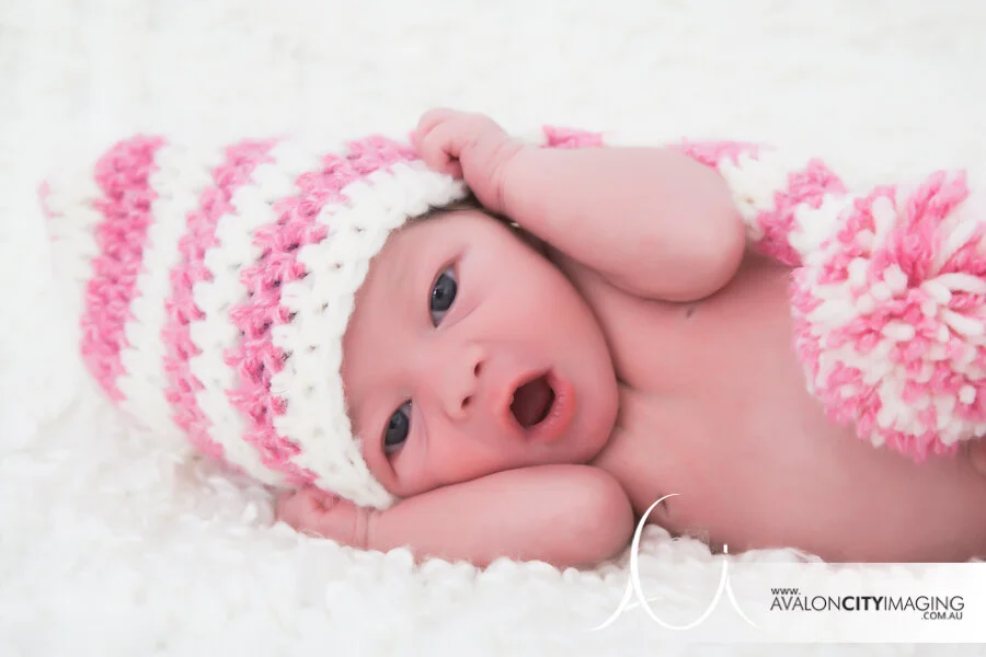 Newborn photography – newborn baby with hands up 