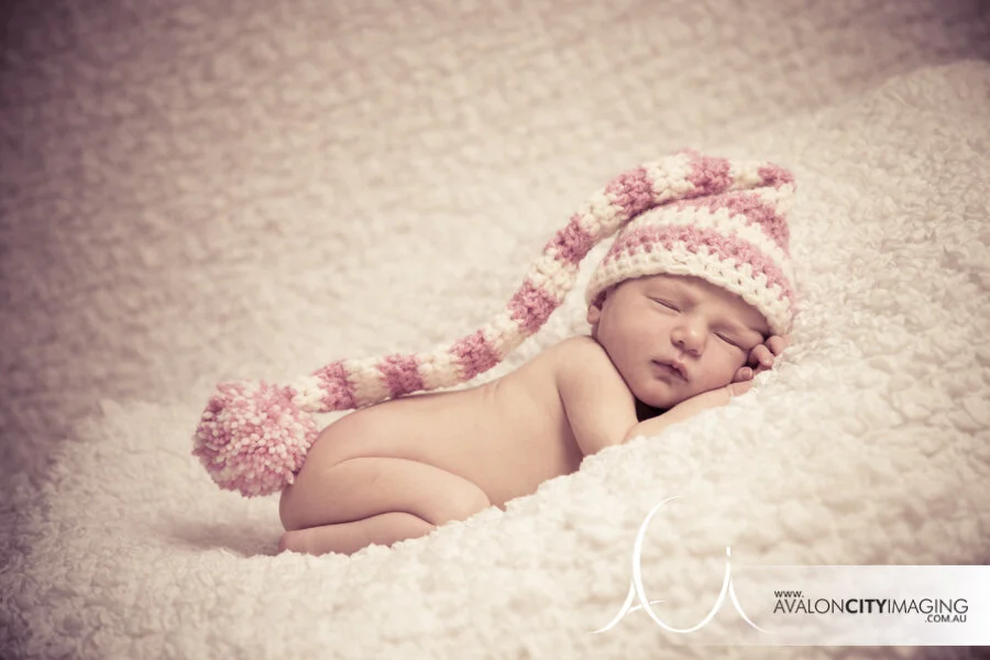 Newborn photography – cute baby posing on wool blanket with filtered editing