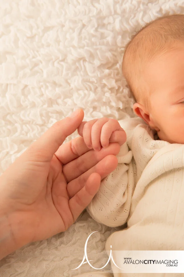 Adelaide newborn photography - Mum holding newborn baby's hand