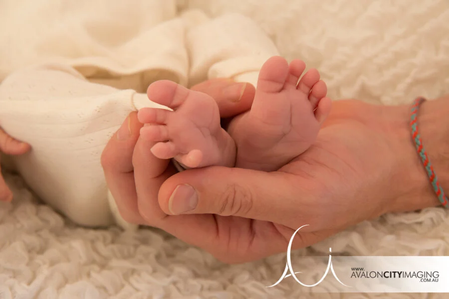 Adelaide Newborn Photography - Newborn baby's feet in parents hand