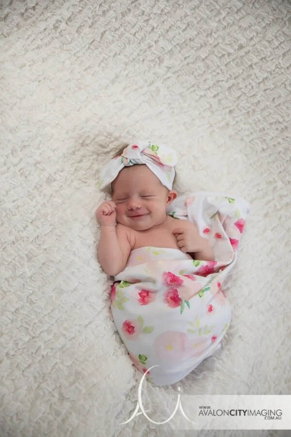 Adelaide Newbiorn Photography - Smiling newborn girl with bow and wrap